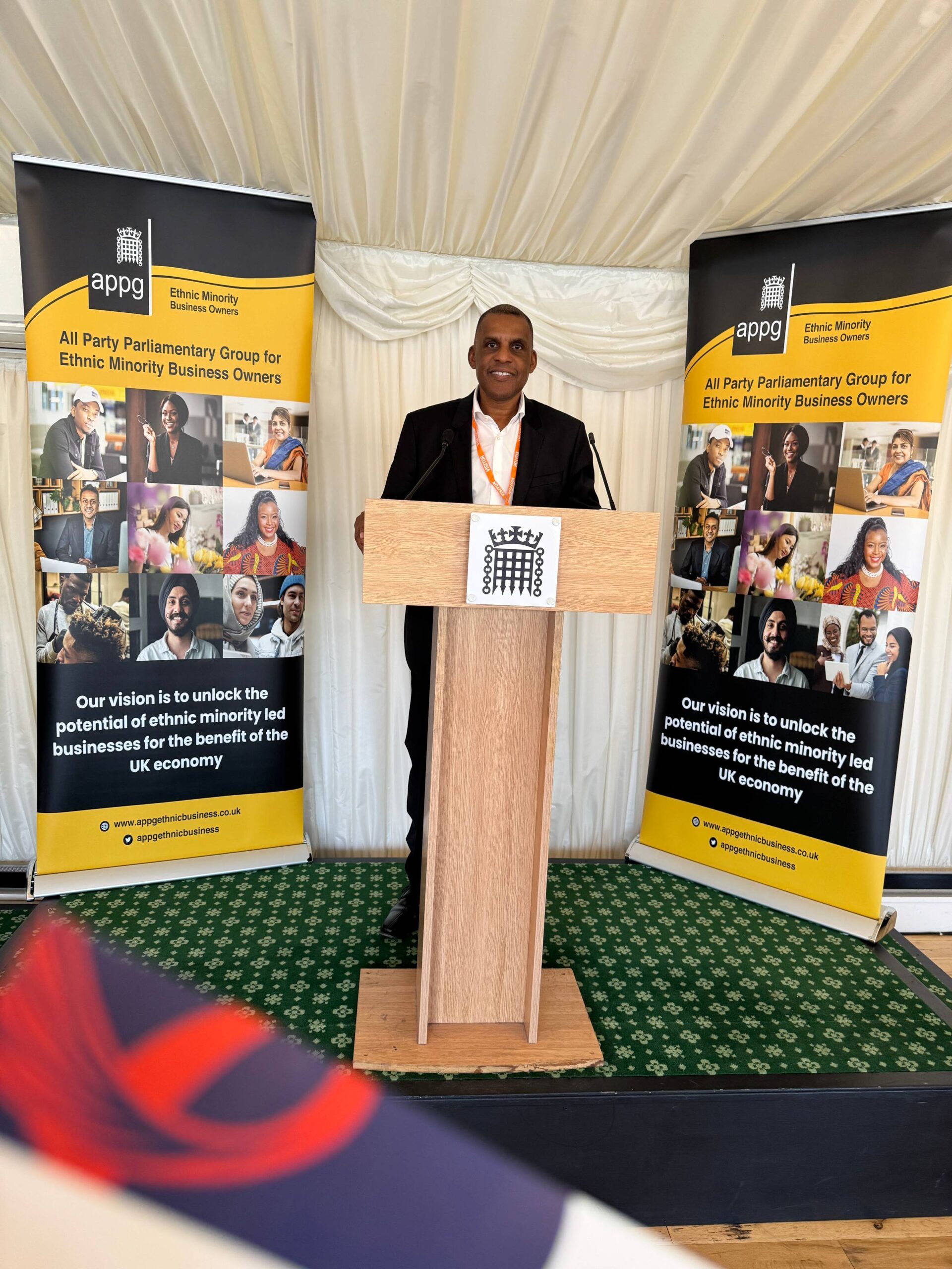 Mike Lawrence speaking from a lectern at an event in the Houses of Parliament
