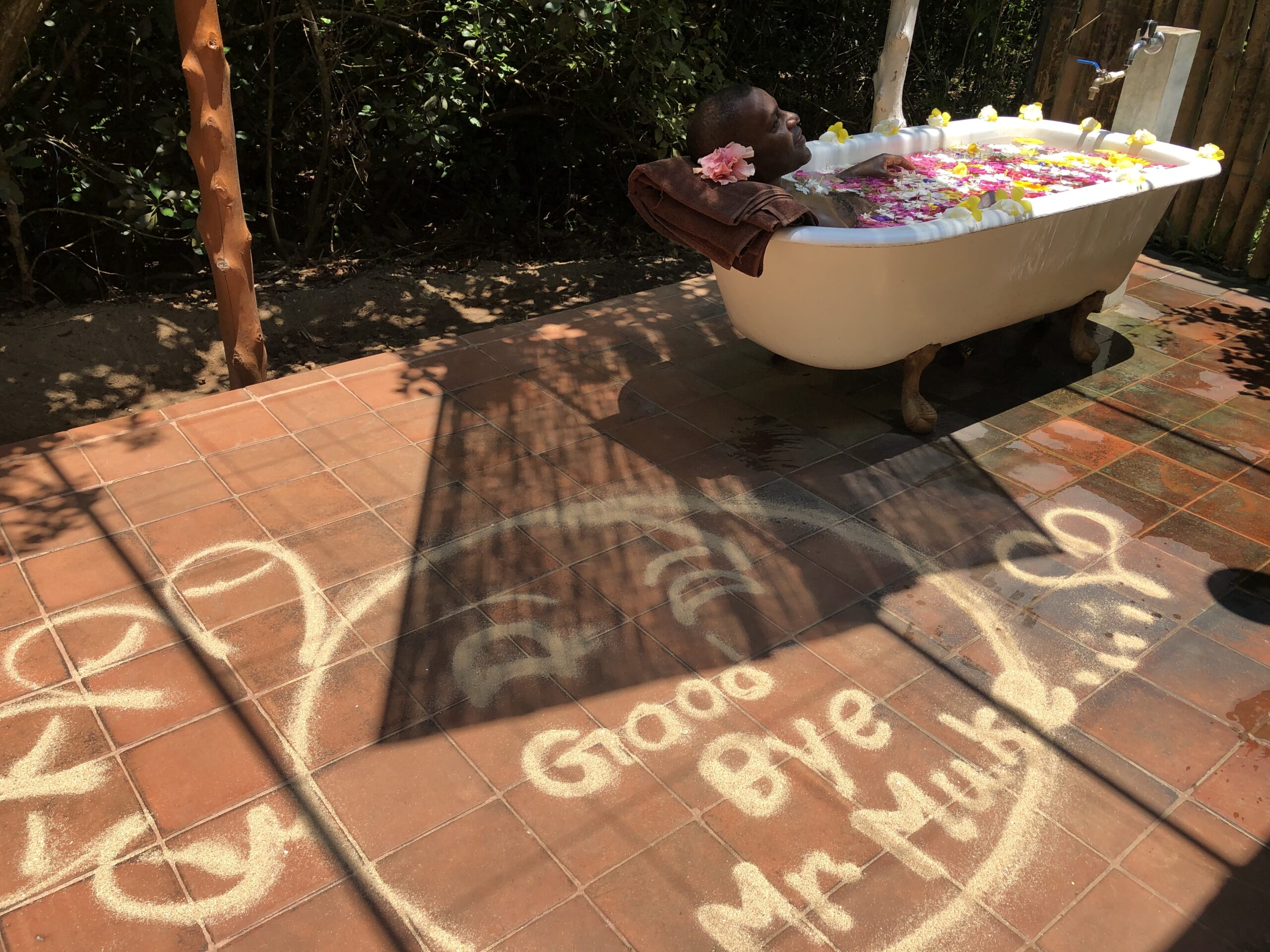 Mike Lawrence relaxing in an outdoor flower bath during a wellbeing retreat in Sri Lanka